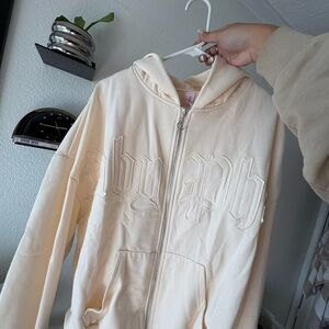 Baby Phat Cream Zip-Up Hoodie with Embossed Gothic Logo